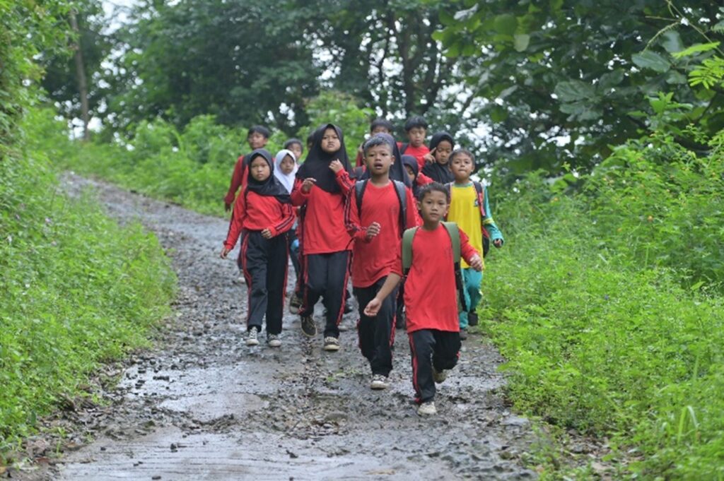 Every day, students walk home along a rocky and slippery path through the valleys of Sumedang, West Java. Their journey can take up to eight kilometres.  